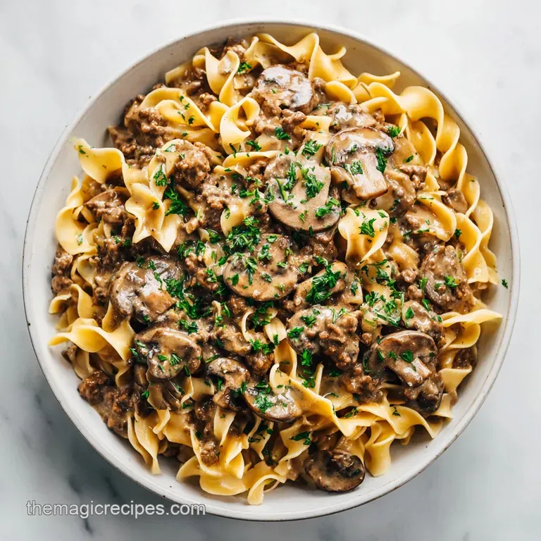 Velvety stroganoff served with vibrant green parsley sprigs and a swirl of sour cream on a dark plate.